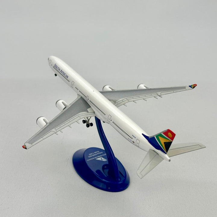 Model airplane of South African Airways on a stand with a plain background