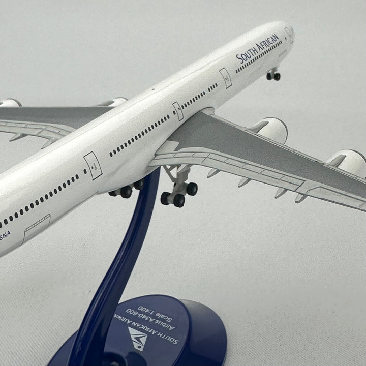 Model of a South African Airways airplane on a stand with a gray background