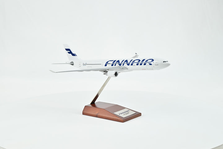 Collector's Finnair Airbus A330-300 1:200 model displayed on wooden stand